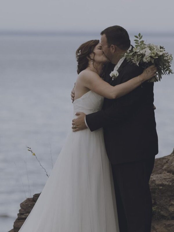 Michelle and Casey sharing their wedding kiss during intimate lakeside wedding ceremony