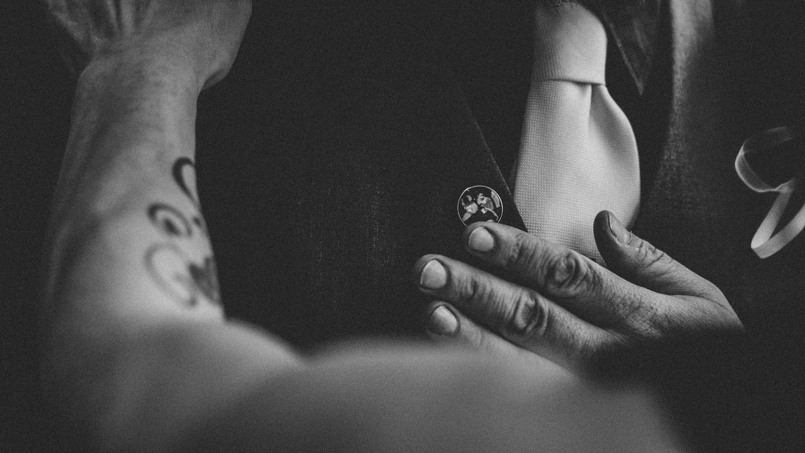 Daniel's getting ready with sister pinning important pin to his jacket