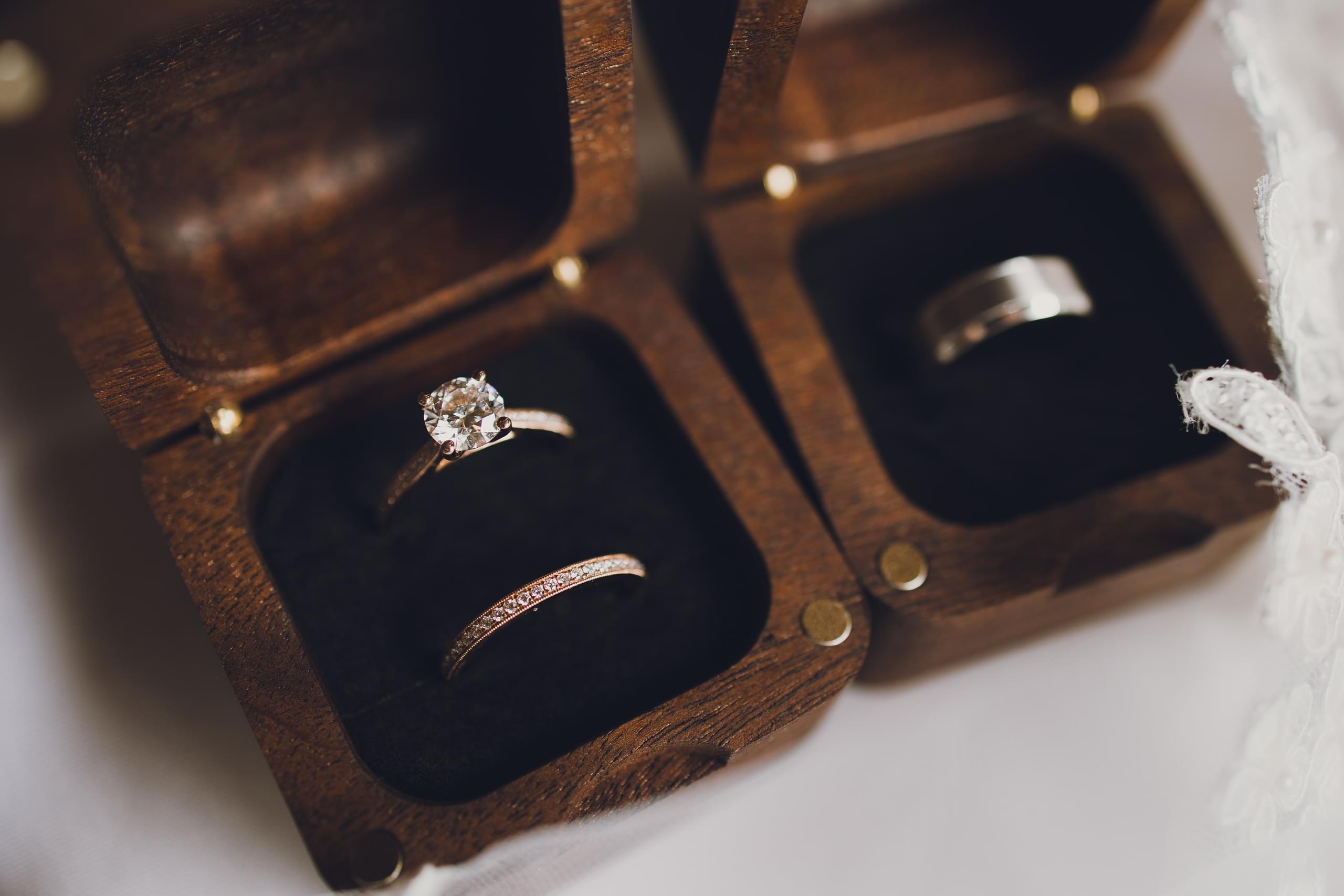 Melissa and Ryan's wedding rings in the boxes for their Duluth wedding at The Garden