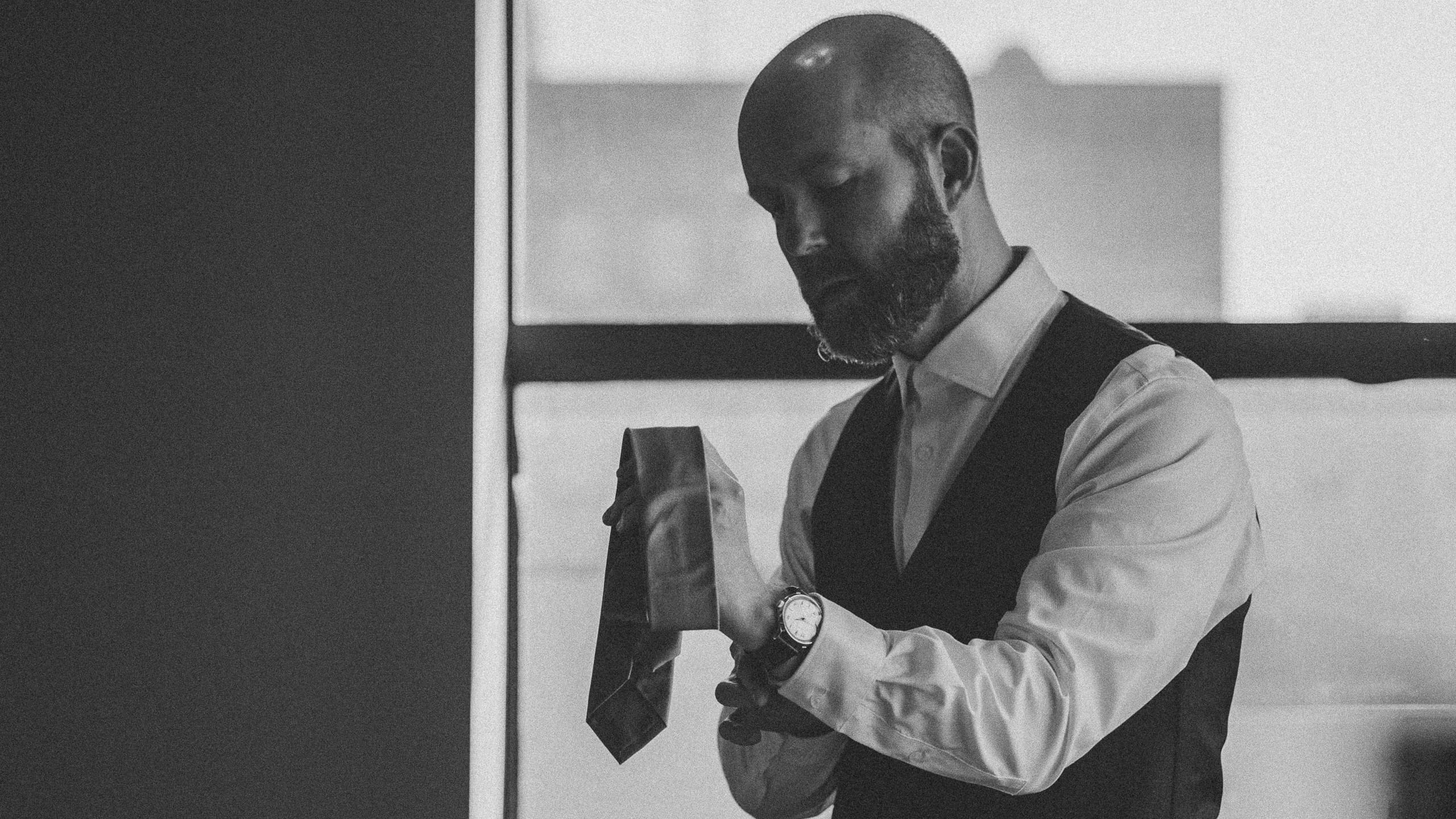 The groom Ryan putting on his watch as he gets ready for his wedding at The Garden Duluth MN