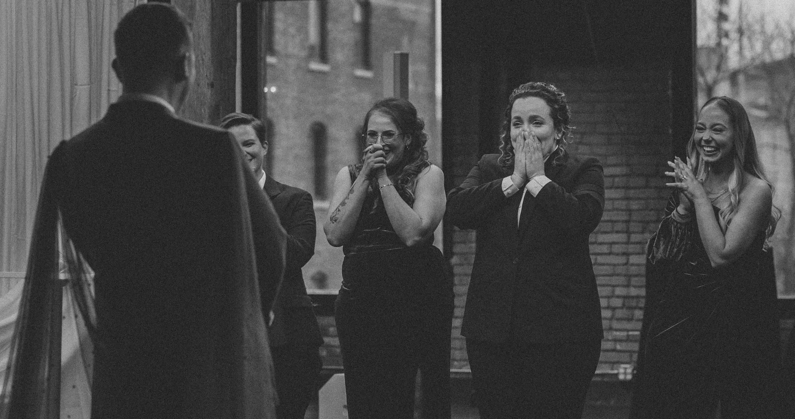 Bryce's first look with his groom's women in the ballroom at the Minneapolis Events Center in black and white