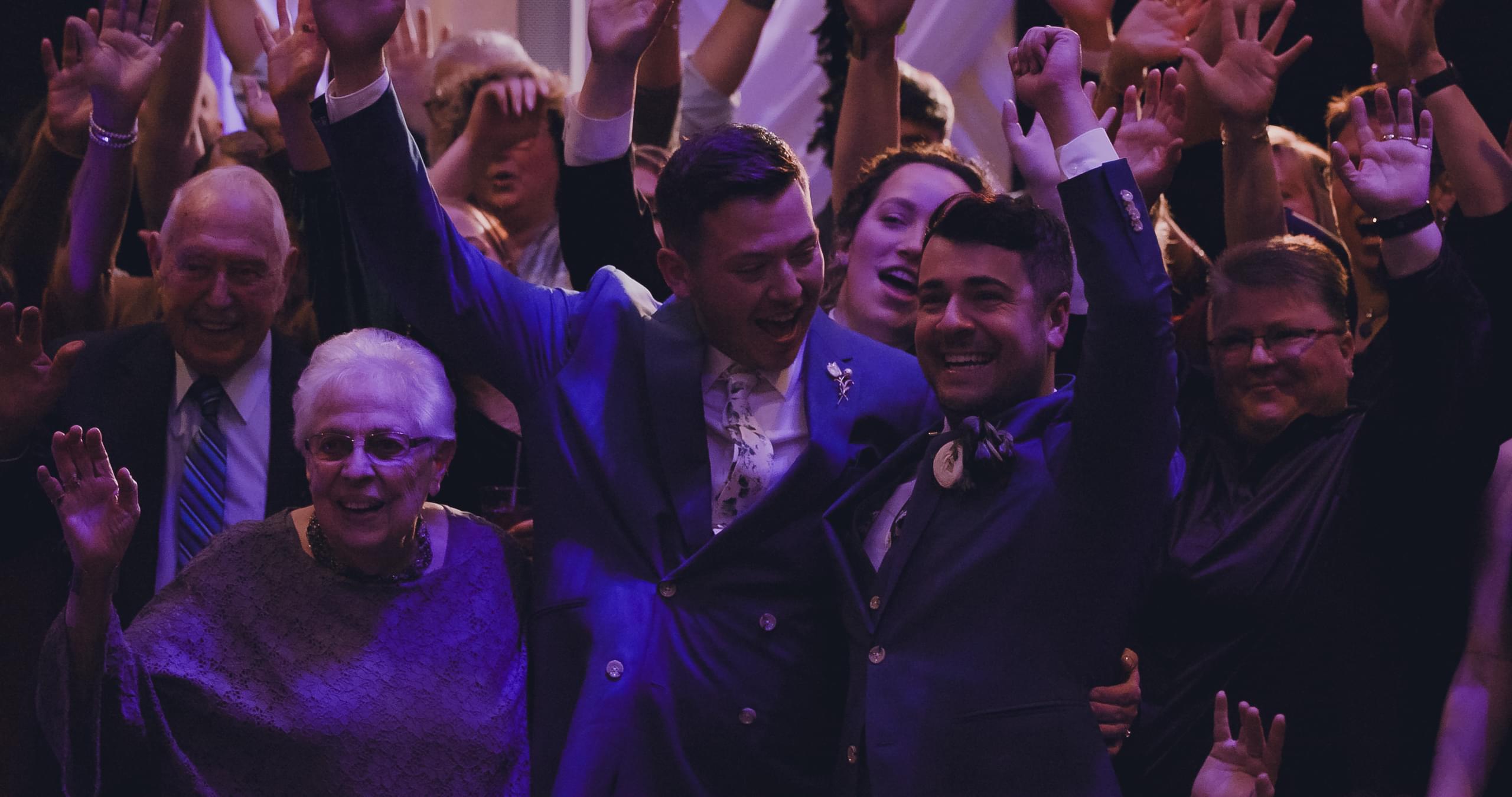 Bryce and Ridge celebrating with friends and family at their Riverside wedding